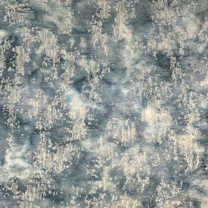 May include: Abstract blue and white fabric with a textured, distressed look. The fabric has a mottled appearance with shades of blue and white.