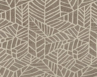 May include: A fabric textile featuring a repeating geometric pattern of stylized leaves in shades of taupe and cream. The design consists of interconnected angular shapes that form a dense, textured leaf motif across the entire surface area.
