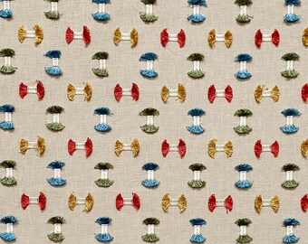 May include: A light beige fabric featuring a repeating pattern of small, embroidered tufted shapes in red, gold, blue, and green. Each tufted element is arranged in a grid, creating a textured surface with a consistent, evenly spaced design.