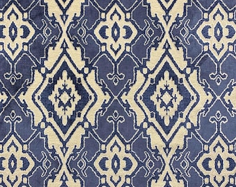May include: A textile fabric featuring a repeating damask-inspired pattern in deep navy blue and cream. The design consists of interconnected diamond shapes and intricate symmetrical floral motifs, creating a dense, woven geometric texture throughout.