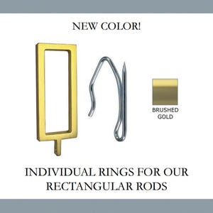 May include: A brushed gold rectangular curtain ring with a small attachment point at the bottom, paired with a silver metal curtain hook. The text reads NEW COLOR! and INDIVIDUAL RINGS FOR OUR RECTANGULAR RODS, with a square brushed gold swatch.