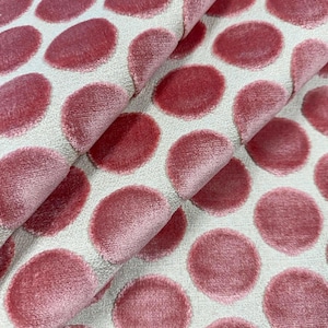 May include: Pink velvet fabric with a white background and a large polka dot pattern.