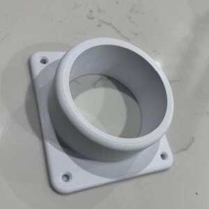May include: White plastic vent adapter with a square base and a round opening. The adapter has four screw holes on the base.