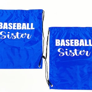May include: Two blue drawstring bags with white text that reads "Baseball Sister".