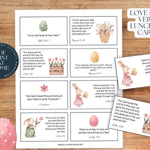 May include: Printable Easter-themed lunchbox cards with Bible verses. Each card features a watercolour illustration of an egg, flowers, or a bunny. The verses include John 3:16, John 14:6, Romans 10:9, Romans 8:34, 1 John 4:18, 1 Corinthians 15:20, Luke 24:6, and John 3:16.