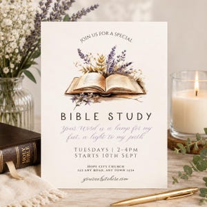 May include: A cream-colored Bible study invitation with an open book illustration and floral accents. The text reads "BIBLE STUDY" and includes event details. A lit candle and a pen are also visible.