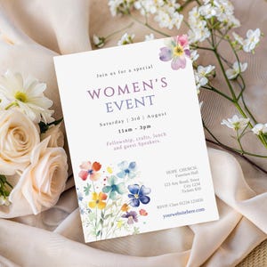 May include: A white invitation card with the text "WOMEN'S EVENT" in purple, featuring watercolor floral accents in blue, yellow, and red. The card includes event details and RSVP information, with a floral background.