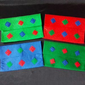 May include: Four felt fabric envelopes with different coloured backgrounds and diamond-shaped patterns in contrasting colours. The envelopes are green, red, blue, and green.