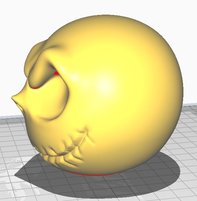 May include: A yellow 3D printed model of a cartoon face with a frown and red eyes. The model is printed in a smooth, glossy finish.