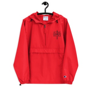 May include: Red Champion brand hooded windbreaker with a black zipper and a black embroidered cross with the text "IC XC NI KA" on the front.