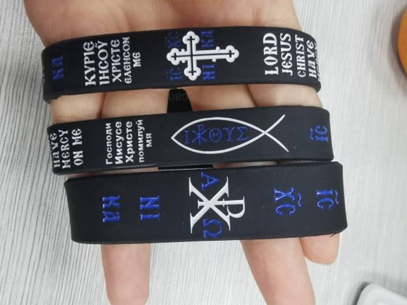 Prayer Wristband Features enamel filled “engraved” Orthodox ICXCNIKA Cross Jesus Fish, The Christ Christogram & Jesus Prayer "Lord Jesus Christ Have Mercy On Me" in English, Greek & Russian.