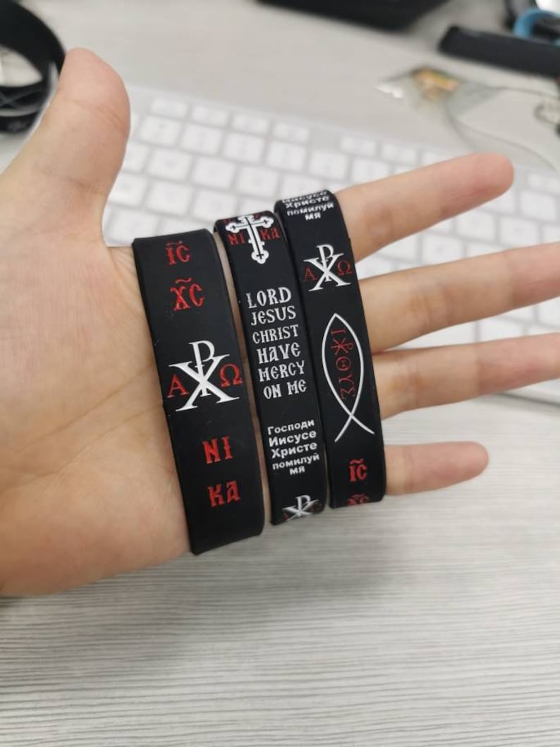 Prayer Wristband Features enamel filled “engraved” Orthodox ICXCNIKA Cross Jesus Fish, The Christ Christogram & Jesus Prayer "Lord Jesus Christ Have Mercy On Me" in English, Greek & Russian.
