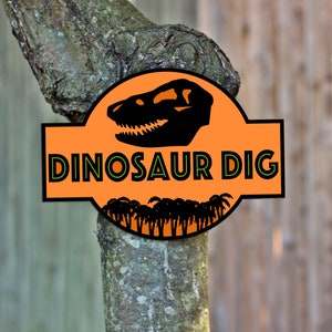 May include: Orange sign with a dinosaur skull and palm trees, reading "Dinosaur Dig".