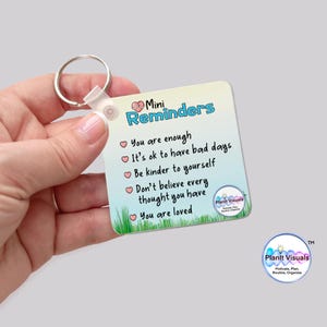May include: A square keychain with a metal ring and a white plastic clasp. The keychain has a gradient background with the words "Mini Reminders" and positive affirmations. The Plantt Visuals logo is in the bottom right corner.