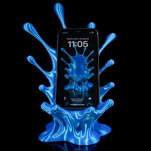 May include: A blue phone stand with a splash design, holding a smartphone. The phone displays the time 11:05 and the date, Thursday, August 1st. The stand is illuminated with blue light against a black background.