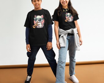 May include: Two children wearing black t-shirts with a cartoon cat playing a trumpet and wearing sunglasses. The cat is white with pink accents. The boy is wearing dark blue pants and black shoes. The girl is wearing blue jeans and white shoes.