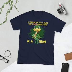 May include: Dark blue t-shirt featuring a cartoon snake and the text "Q: What do you call a snake that's 3.14 metres long? A: A πthon". The snake is green and yellow.