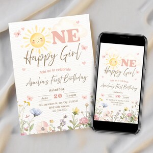May include: A birthday invitation and a smartphone displaying the same design. The invitation features a smiling sun, the words "Happy Girl," and floral accents. The text reads "Amelia's First Birthday" and includes date and time.