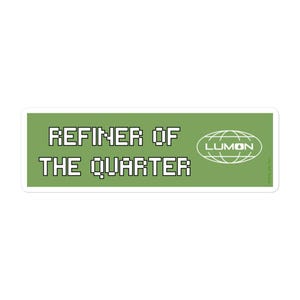 May include: A rectangular sticker with a green background and white text. The text reads "REFINER OF THE QUARTER" in a pixelated font. The Lumon logo is on the right side.
