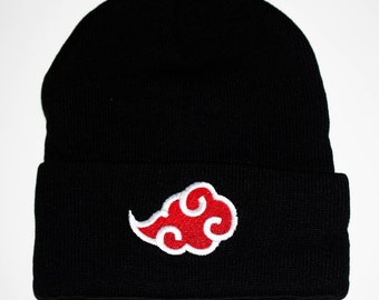 May include: Black beanie with a red and white cloud design. The cloud is a stylized symbol with a white outline and a red interior.