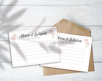 May include: Two white cards with the text "Advice & Wishes FOR THE BRIDE" and floral accents. The cards are on a white wooden surface with a brown envelope. The cards have lines for writing.