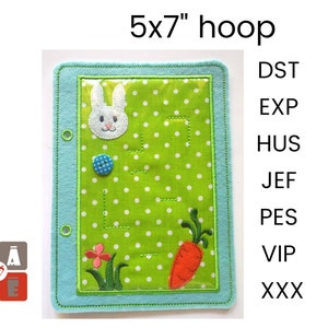 May include: A 5x7 inch embroidery hoop with a green felt background and a white bunny rabbit, a red carrot, and a green flower design. The hoop has a clear plastic window and a blue felt border. The text "DST, EXP, HUS, JEF, PES, VIP, XXX" is visible on the right side of the image.