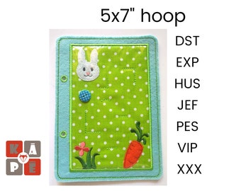 May include: A 5x7 inch embroidery hoop with a green felt background and a white bunny rabbit, a red carrot, and a green flower design. The hoop has a clear plastic window and a blue felt border. The text "DST, EXP, HUS, JEF, PES, VIP, XXX" is visible on the right side of the image.
