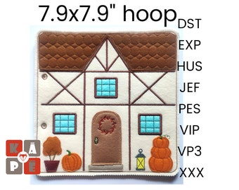May include: A felt play mat with a brown house with a wreath on the door, two windows, and a brown roof. There are two pumpkins and a lantern in front of the house. The mat is 7.9 inches by 7.9 inches.