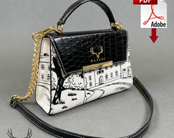 May include: A black and white handbag with a top handle and a gold chain strap. The top flap is black with a crocodile texture. The bag features a cityscape design and the brand name "PaJust".