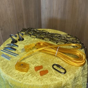 May include: A lighting installation kit featuring a long yellow electrical cord with a plug, a yellow plastic switch, two bronze-toned ceiling hooks, a metal chain, two orange wire nuts, a metal carabiner, and various metal mounting hardware.