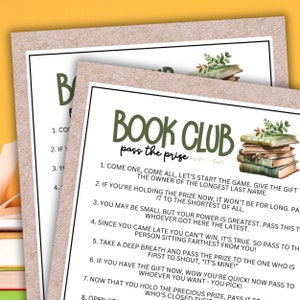 May include: A printable game card with green text that reads "Book Club Pass the Prize". The card has instructions for a game where players pass a gift around a circle. The card features a watercolor illustration of a stack of old books with green leaves.
