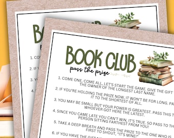 May include: A printable game card with green text that reads "Book Club Pass the Prize". The card has instructions for a game where players pass a gift around a circle. The card features a watercolor illustration of a stack of old books with green leaves.