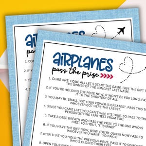 May include: A blue and white printable game card with the title "Airplanes Pass the Prize" and instructions for a party game. The card features a red heart with a plane flying out of it.