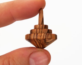 Tiny olive wood spinning tops, tops in different shapes, mini spin tops, wooden spinning tops, olive wood toys, by josef woodturner