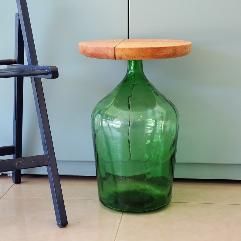 Side table made by a green demijohn (as the table's leg) with the addition of a handmade wooden round top made of red oak, white oak, ash and mulberry wood.