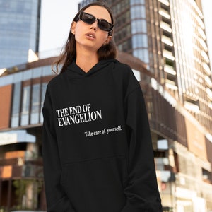 May include: Black hooded sweatshirt with white text that reads "THE END OF EVANGELION" and "Take care of yourself."