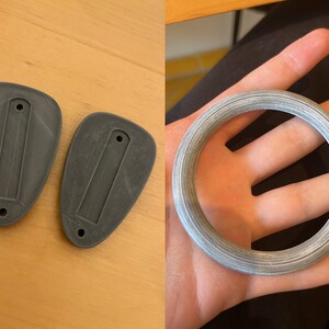 May include: Two gray plastic pieces with a rectangular cutout and a small hole on each side. A gray plastic ring with a textured surface.
