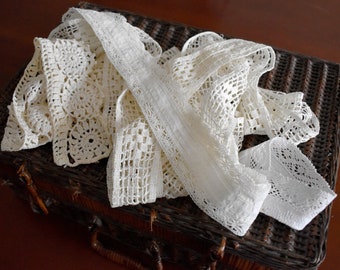 May include: A wicker basket filled with white crocheted lace trim and doilies.