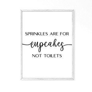 May include: White framed print with black text that reads "Sprinkles are for cupcakes not toilets".