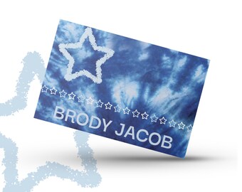 May include: Blue tie-dye card with a white star and the name "Brody Jacob" printed in white.