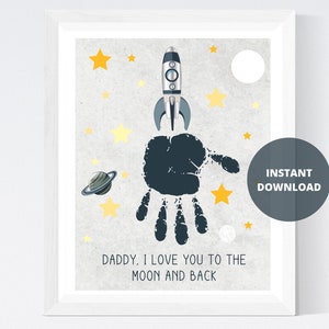 May include: A printable art print with a black handprint, a rocket, stars, and a planet. The text reads "Daddy, I love you to the moon and back".