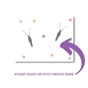 May include: A white card with a purple arrow pointing to the bottom right corner. The card has two gray butterfly silhouettes and colorful flower accents. The text "STAMP HAND OR FOOT PRINTS HERE" is at the bottom of the card.