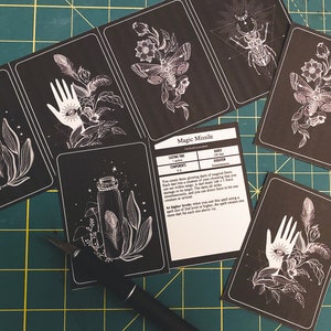 May include: A set of black and white printable cards featuring illustrations of a hand, a bottle, a moth, and a beetle. The cards also include a text card with the title "Magic Missile" and information about the spell.