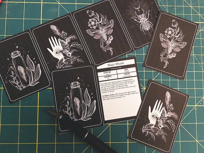 May include: A set of black and white printable cards featuring illustrations of a hand, a bottle, a moth, and a beetle. The cards also include a text card with the title "Magic Missile" and information about the spell.