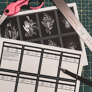 May include: A printable sheet of paper with a black and white illustration of a hand with an eye on the palm. The sheet is labeled "Magic Missile" and has a table with the headings "Casting Time", "Range", "Components", "Duration", and "School".