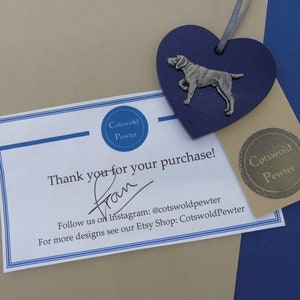 May include: A thank you card with a blue heart-shaped pewter charm featuring a silver dog. The card says "Thank you for your purchase!" and includes the text "Cotswold Pewter" and "Follow us on Instagram: @cotswoldpewter".