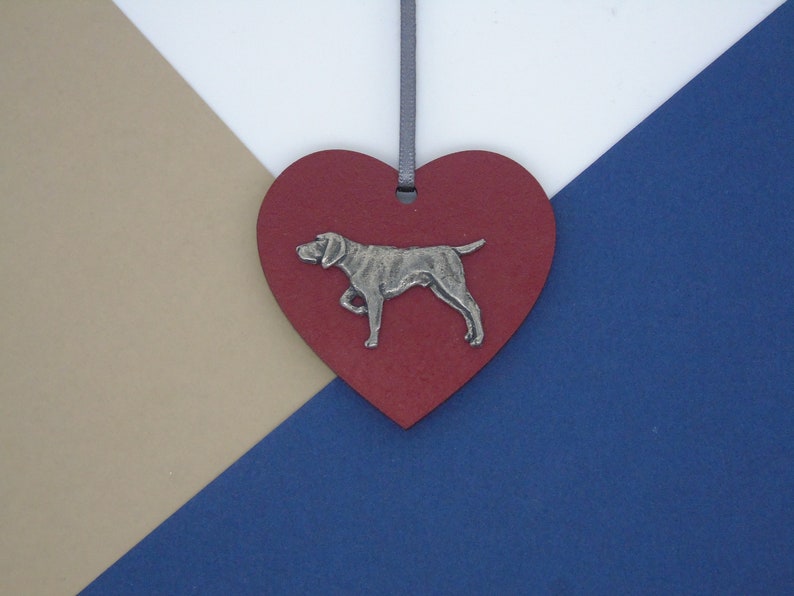 May include: A red heart-shaped wooden ornament with a silver metal German Shorthaired Pointer dog silhouette.