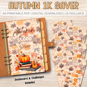 May include: A digital autumn-themed financial planner with a brown leather binder. The planner features a pumpkin, books, and a drink illustration. The text reads "Autumn 1K Saver" and includes challenge cards with amounts. A6 printable PDF.