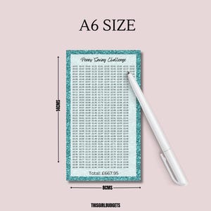May include: A rectangular A6 size Penny Saving Challenge tracker card with a teal glitter border. The card features a grid of monetary values in pounds, a total of &pound;667.95, and a white pen. Dimensions are 14 cm by 8 cm as indicated by arrows.