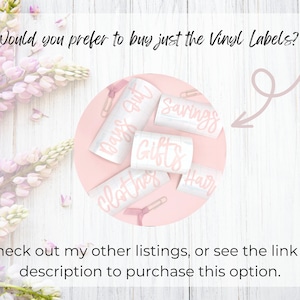 May include: A close-up of a set of pink vinyl labels with the words "Days Out", "Savings", "Gifts", "Clothes", and "Hair" written on them. The labels are on a pink background with a white wooden surface in the background.